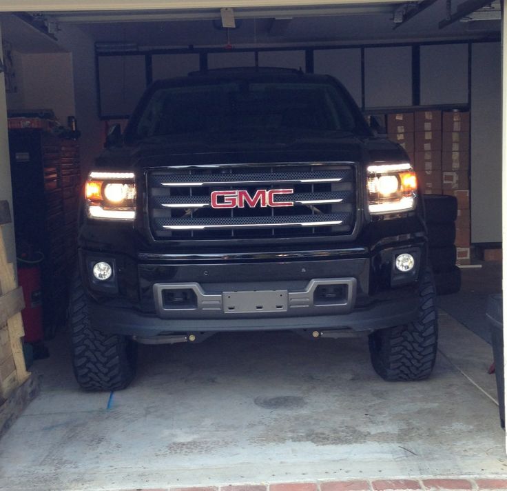 black lifted GMC in garage front grille view | See more about Garages and Black.