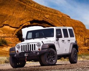 Jeep automobile - Sandstone Arch in Rock Moab Utah